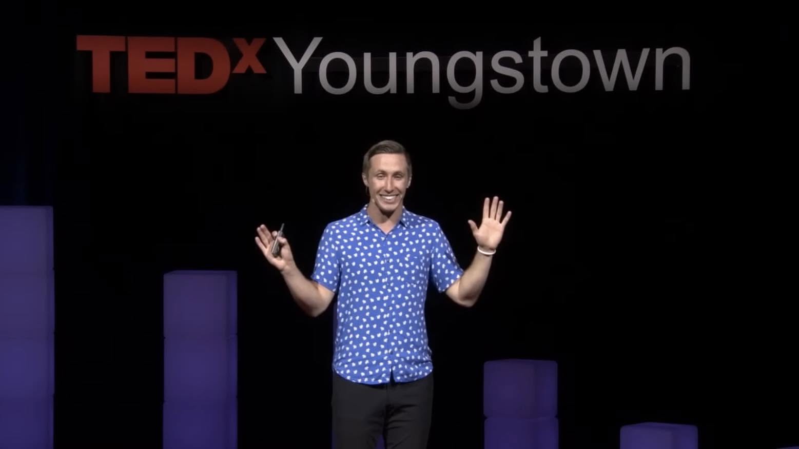 Chandler Bolt speaking on stage at TEDx Youngstown